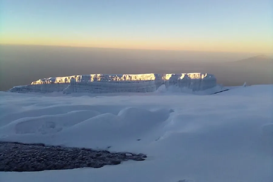 Kilimanjaro remote northern slopes — vast wilderness with summit cone above