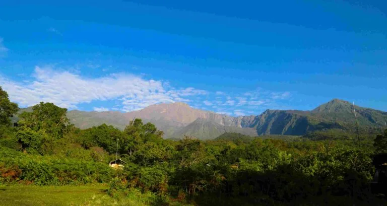 Mount Meru trekking route — crater rim trail and Socialist Peak summit with Kilimanjaro in background