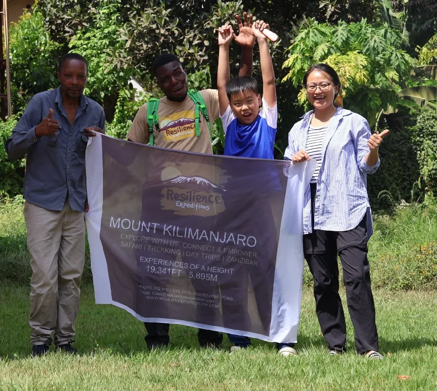 Resilience Expeditions guide with guests watching elephant herd at Tarangire River