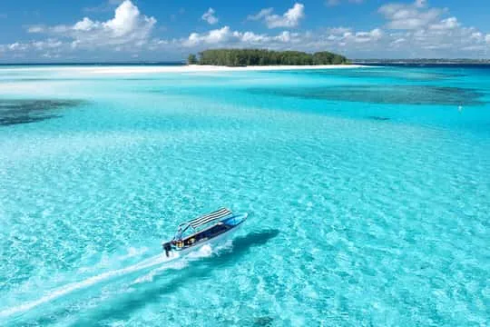 Zanzibar beach Tanzania — white sand, turquoise water, dhow sailboat